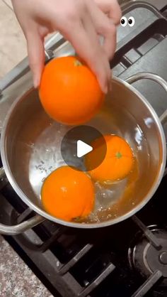 someone is cooking oranges in a pan on the stove