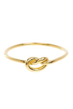 a gold ring with an intertwined knot on the front and center, set against a white background