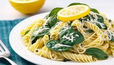 a plate of pasta with spinach and lemon