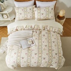 a bed with white sheets and flowers on it