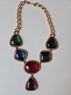 Incredible massive designer multi color large cabachon and gold necklace by KJL for AVON! This amazing 90's collectors necklace is the perfect next addition to your jewelry collection.  This necklace is the prefect statement piece for any outfit, formal or casual.  Dress it up or dress it down with a great T shirt and jeans or a fabulous evening gown. We just LOVE this amazing statement necklace. Get this gorgeous designer vintage necklace for yourself or for someone in your life who loves vintage jewelry! Neck Drop 8 inches Length 11 inches My photos are shots of the original item. Light or dark spots are reflections caused by the lighting. Color deviations can occur depending on the screen being used. Age of items are estimated based on my research and experience. Age differences may occ Navy Blue Purse, 80s Jewelry, Runway Necklace, 90s Jewelry, Vintage Hair Combs, Designer Necklace, Blue Purse, Chunky Jewelry, Neck Jewellery