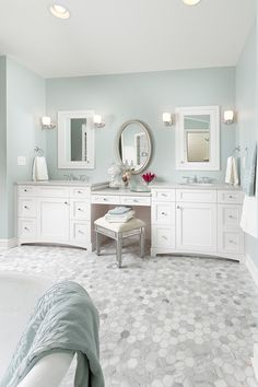 a large bathroom with blue walls and white fixtures