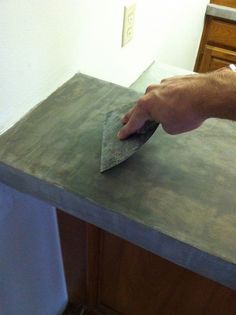 a person using a rag to clean a counter top