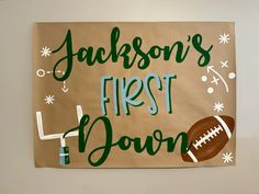 a paper sign that says, jackson's first down with a football on it