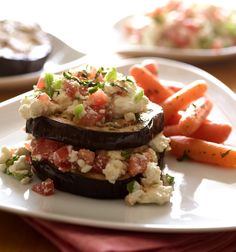 an eggplant and cauliflower dish on a plate with carrots