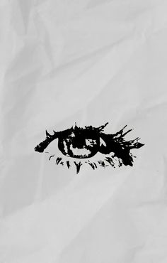 a black and white photo of an eye drawn on a piece of paper with ink