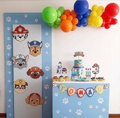 a birthday party with paw patrol decorations, balloons and paper cutouts on the wall