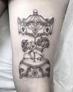 a black and white photo of a carousel tattoo