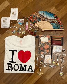 i love roma t - shirt, keychains, and other items laid out on the floor