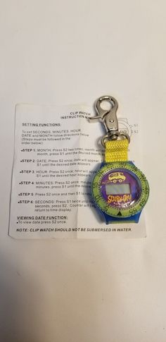 a keychain that is attached to a piece of paper with an advertisement on it