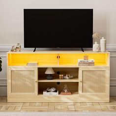 an entertainment center with a flat screen tv mounted on it's side, in front of a white wall