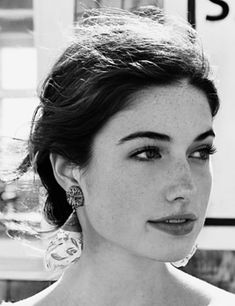 black and white photograph of a woman wearing earrings