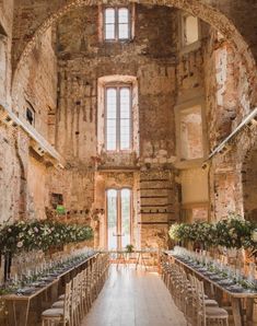 the inside of an old stone building with tables and chairs set up for a wedding