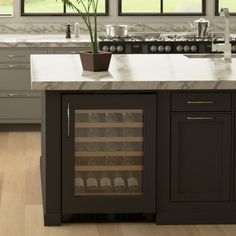 a wine cooler in the middle of a kitchen counter