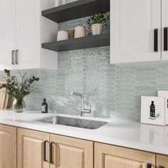 a kitchen with white cabinets and countertops has plants on the shelf above the sink