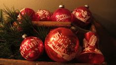 a wooden box filled with red christmas ornaments