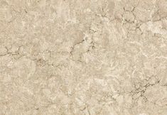 a close up view of a white marble textured wall or floor tile with light brown streaks on the surface