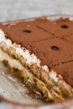 a piece of cake on a plate with chocolate chips and frosting in the middle