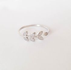 Leaf ring - Sterling Silver Laurel Ring - Leaf Branch Ring - Wrap cz Leaf Ring-CZ Leaves Ring-Open CZ Ring-Tiny Diamonds Cuff Ring Adjustable leaves branch wrapped open ring in sterling silver 925. Ring crafted from sterling silver 925 and CZ tiny diamonds. Click here for more rings https://www.etsy.com/il-en/shop/MoonliDesigns?ref=hdr_shop_menu&section_id=21288938 ► Nickel Free ✔ ► Tarnish Resistant ✔ ► No Allergic reaction ✔ ► 30 days return policy ✔ ► Accept replacements and custom orders Cubic Zirconia Midi Promise Ring, Silver Stackable Midi Rings With Cubic Zirconia, Dainty Silver Ring With Diamond Accents, Silver Cubic Zirconia Midi Rings As Promise Rings, Silver Cubic Zirconia Midi Rings For Promise, Silver Cubic Zirconia Midi Rings, Silver Midi Rings With Diamond Accents For Promise, Adjustable Silver Diamond Midi Rings, White Gold Cubic Zirconia Midi Rings As Gift