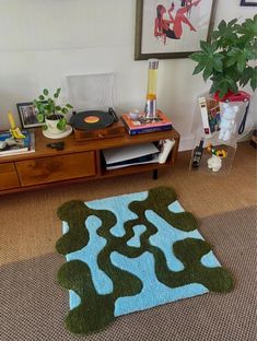 a living room with a blue and green rug on the floor next to a record player