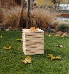 a wooden box sitting on top of a lush green field