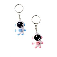 two key chains with an image of a small toy on one side and the other