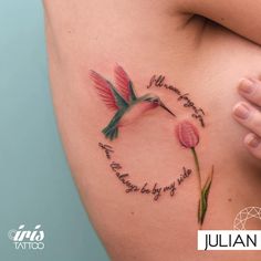 a woman's stomach with a hummingbird tattoo on it and the words written in cursive writing