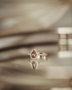 a diamond ring sitting on top of a table