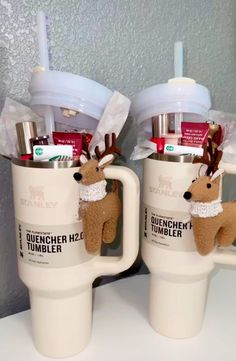 two coffee mugs with reindeer decorations on them