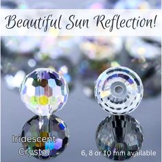 two clear crystal beads with the words beautiful sun reflection on them and an image of several different colors