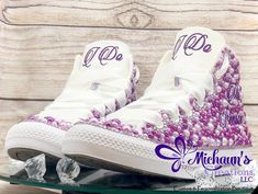 "Michaun's Creations can offer you affordable options as it relates to your special day. Our Bling and Pearl Wedding Sneakers come in either the 100% authentic Converse brand high-top sneakers or a more affordable Converse Alternative. The photo in this listing show the beauty of the authentic Converse brand. Each pair of sneakers, whether you choose the Authentic or Alternative brand of Converse, is designed by hand using high-quality glass and resin rhinestones and pearls. All personalizations are done in glitter heat transfer vinyl. Customization includes the choice of rhinestone trim color, pearl color, and personalization design choices and colors. Your custom order options include: * White or colored high-top Converse or Alternative Brand (white only) sneakers designed in your prefer Converse Alternative, Sneaker Wedding, Colored Converse, White Tongue, Bridal Sneakers, Bling Converse, Wedding Converse, Glitter Heat Transfer Vinyl, Wedding Sneakers