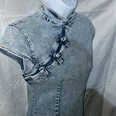 a mannequin wearing a jean jacket with an attached collar