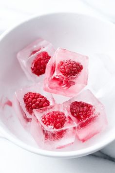 raspberry ice cubes in a white bowl