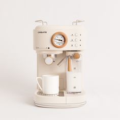 an espresso machine sitting on top of a white counter