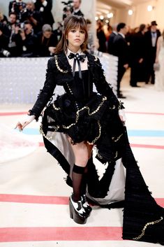 a model walks the runway in a black and white dress with ruffles on it