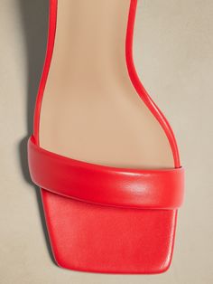 Set atop a sculpted, flare heel, these square-toe sandals have an ankle strap for a secure fit.  Each pair is expertly crafted in Portugal from beautiful, Italian leather.  Italian leather uppers and lining.  Rubber soles.  Buckle at ankle.  Made in Portugal.  B width.  Heel height: 3. 75" Red Heels With Sculpted Heel And Single Toe Strap, Red Square Toe Heels With Stacked Heel, Bold Open Heel Heels With Sculpted Heel, Bold Open Heel Heels With Sculpted Design, Bold Heels With Sculpted Open Heel, Chic Red Sandals With Reinforced Heel, Red Sandals With Sculpted Low Heel, Bold Sandals With Heel And Ankle Strap, Bold Leather Heels With Sculpted Heel