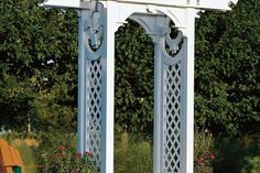 a white gazebo sitting in the middle of a garden