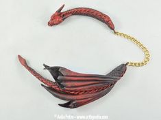 THIS ITEM IS PRESENTLY IN-STOCK AND READY TO SHIP OUT WITHIN 5 BUSINESS DAYS.This Dragon Draper will be painted in shades of black and red, with black speckle details along the trailing edges of the wings, with black and red horns, and black eyes and teeth. Each necklace will consist of 2 pieces, a head and a tail, which drape around your shoulders.. Both pieces are cast in resin from an original sculpture. The pieces will be connected by a short section of chain, making the necklace adjustable Black And Red Dragon, Nordic Wedding, Paper Dolls Clothing, Handmade Clay Jewelry, Dragon Earrings, Polymer Clay Jewelry Diy, Felt Jewelry, Dragon Necklace, Dragon Jewelry