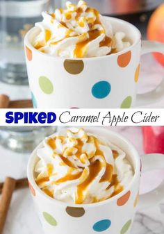 two mugs filled with caramel apple cider whipped cream and topped with apples