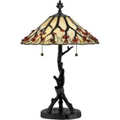 a lamp that is sitting on top of a wooden stand with a bird on it