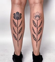 a woman's legs with tattoos and flowers on them