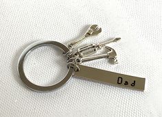 a pair of scissors with the word dad engraved on it