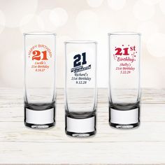 three shot glasses with 21st birthday designs on them