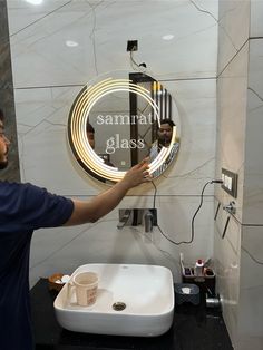 a man is cleaning his glass in front of a mirror with the words samurai glass on it