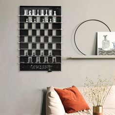 a living room filled with furniture and a wall mounted chess board on top of it