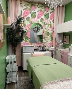 a room with green walls and pink flowers on the wall