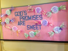 a pink sign that says god's promisses are sweet with candy candies on it