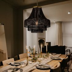 a dining room table is set with plates and place settings