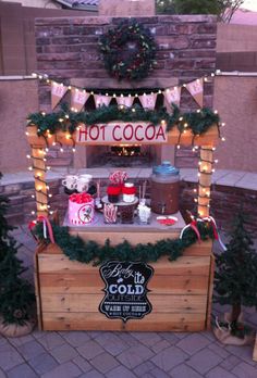 a hot cocoa stand with christmas decorations and lights