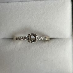 a diamond ring is sitting on top of a white box